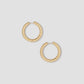Gold hoop earrings on a light gray background