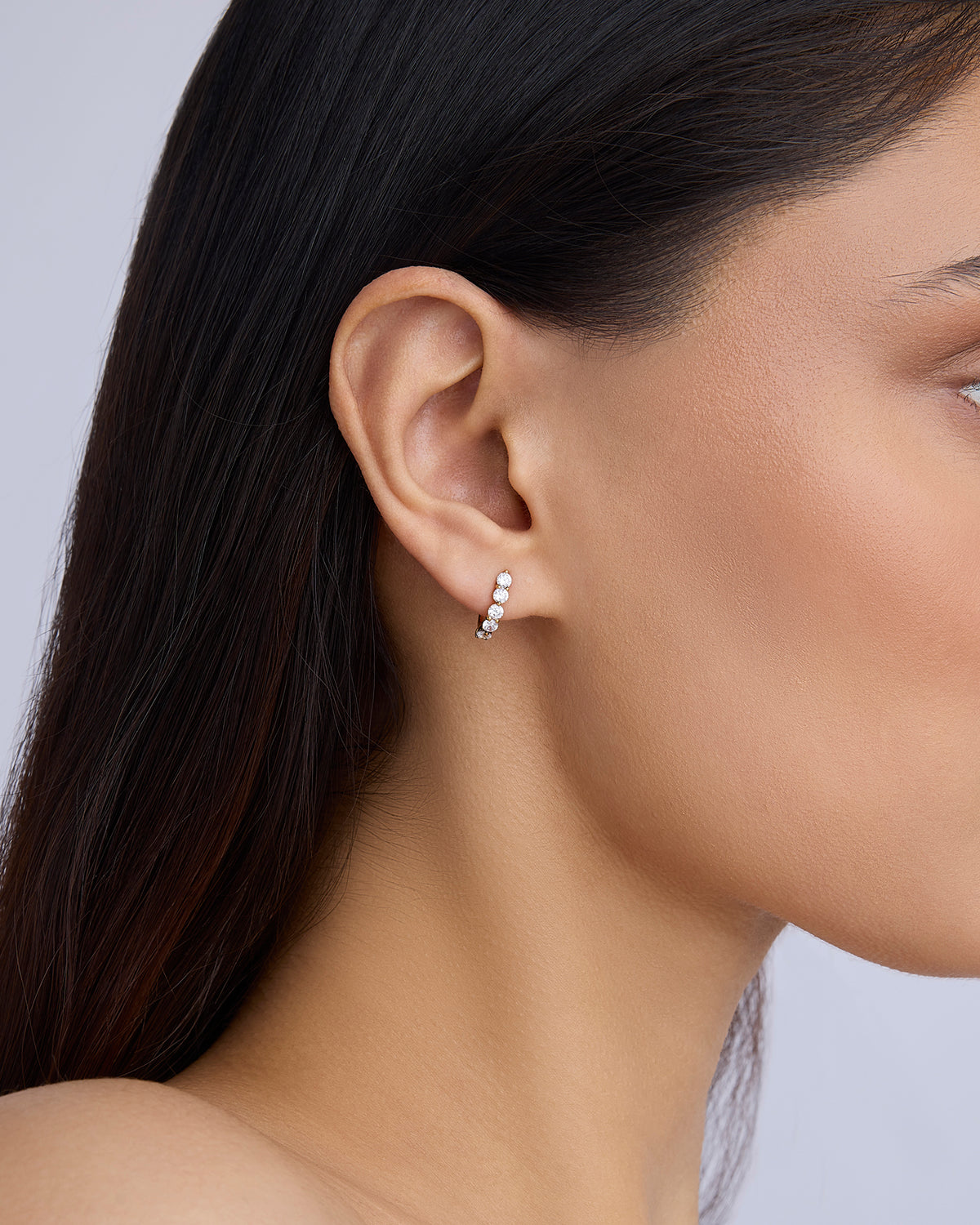 Floating Five Diamond Huggies 18K gold earring - close-up detail | diamond huggie earrings